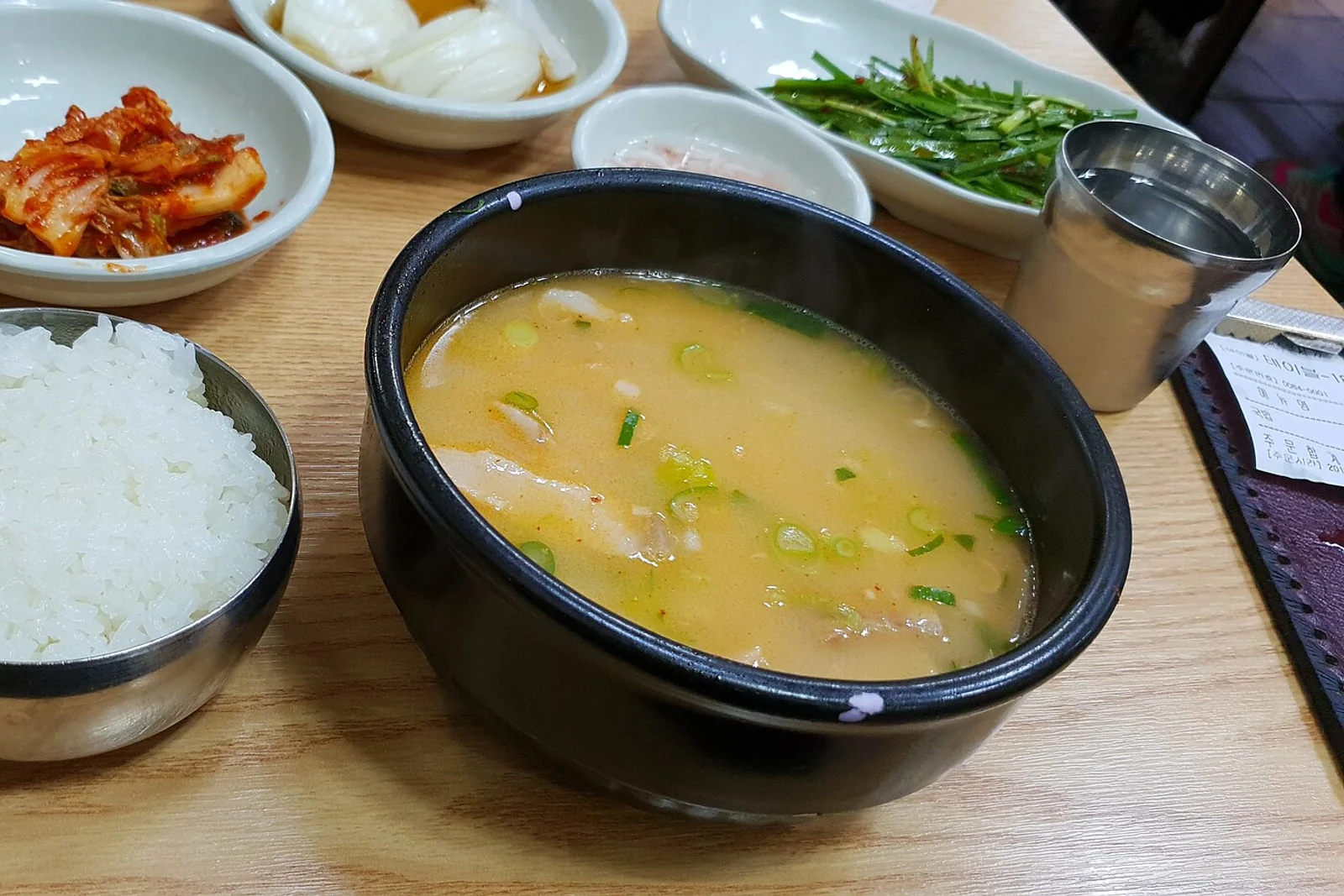 A bowl of Busan-style dwaeji gukbap pork soup