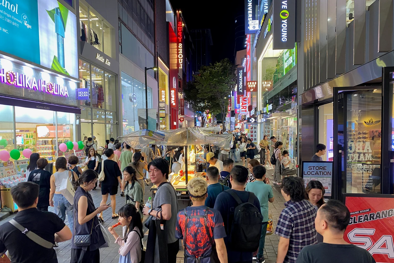 Food stalls and visitors at Myeongdong Night Market in Seoul